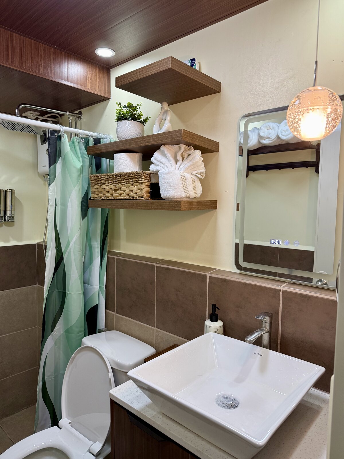 Square vessel sink and mirror, with towels on floating shelves above.